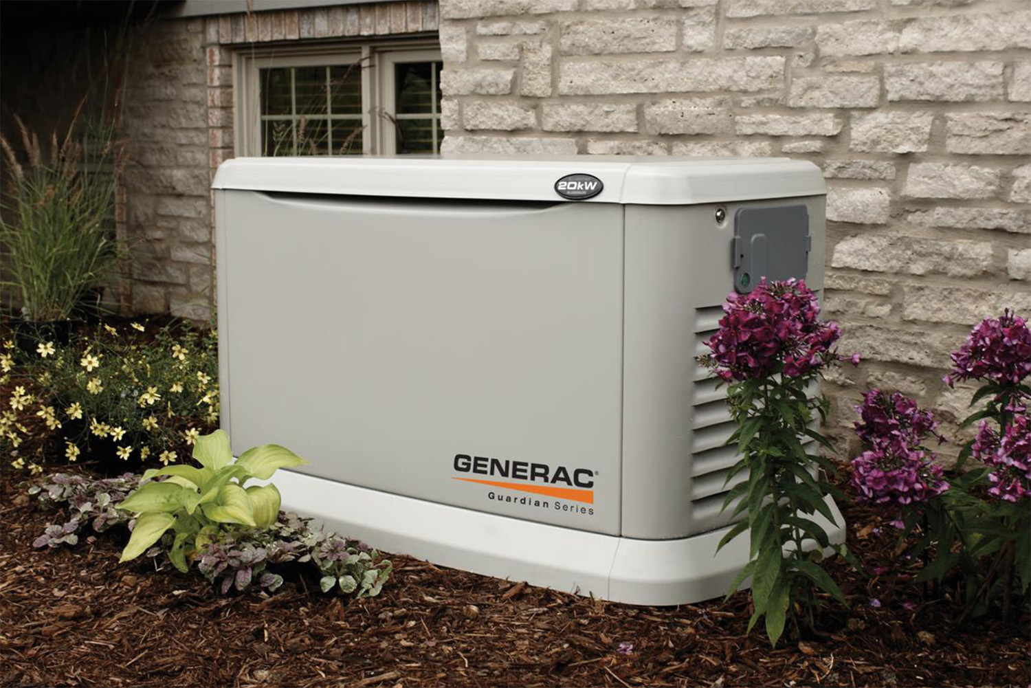 Generac Guardian Series home standby generator installed outside a Michigan home by Webster Electric, surrounded by landscaping and flowers.