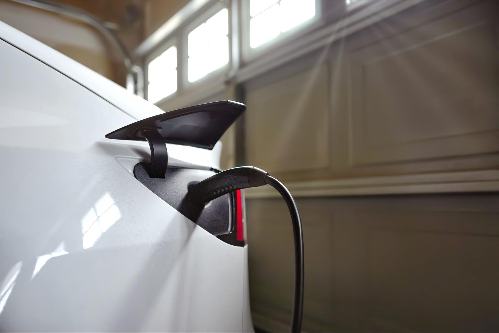 Electric vehicle charging at a home EV charger in a garage