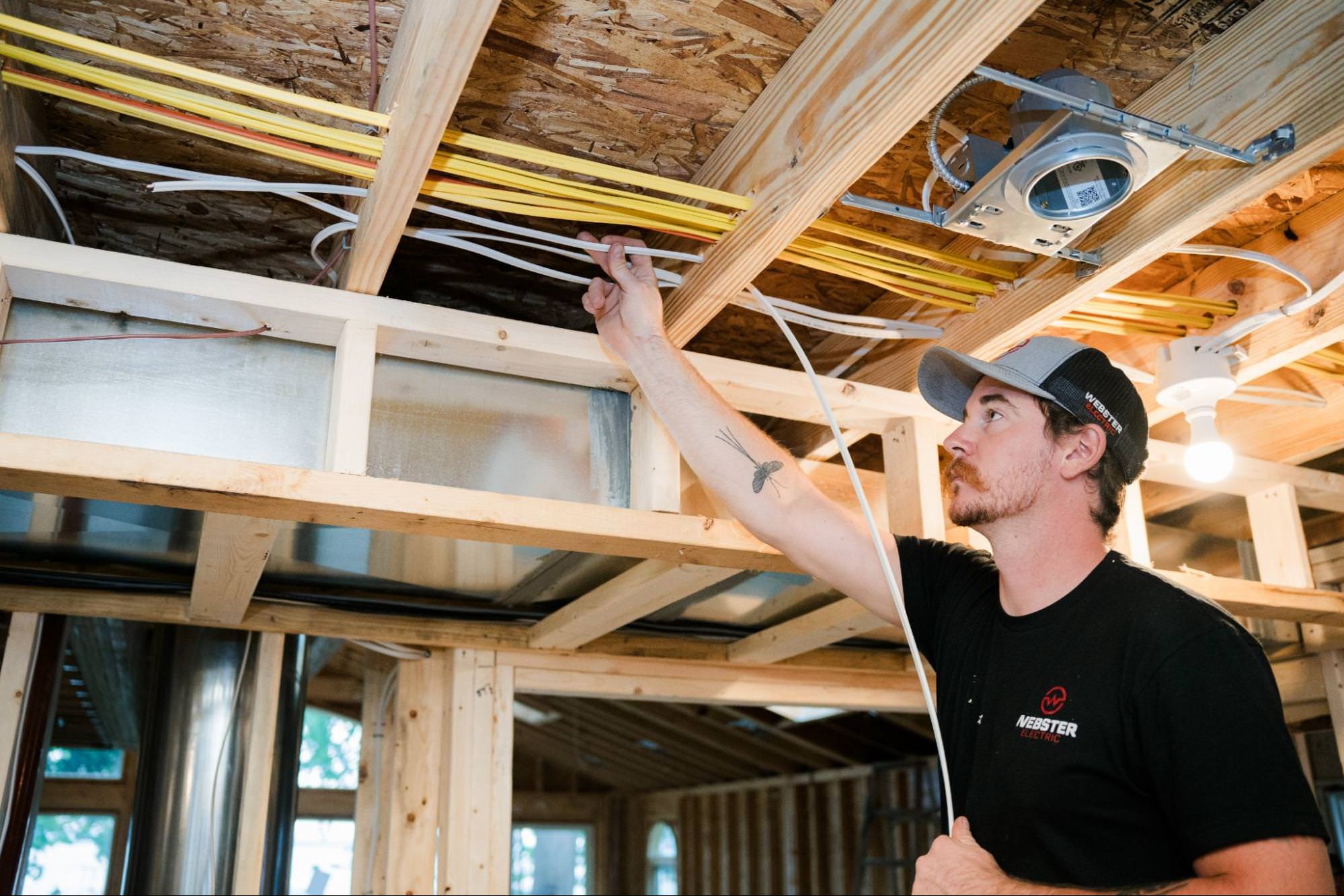 Webster Electric electrician working on residential electrical wiring in a Kalamazoo home.